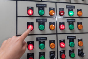Hand of engineer working and check status switchgear electrical energy distribution at substation room